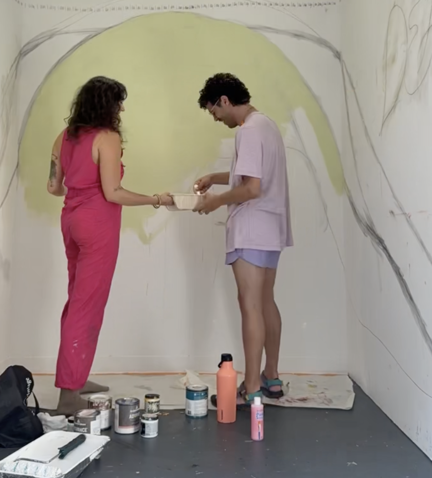 Quincee and client mixing paint together