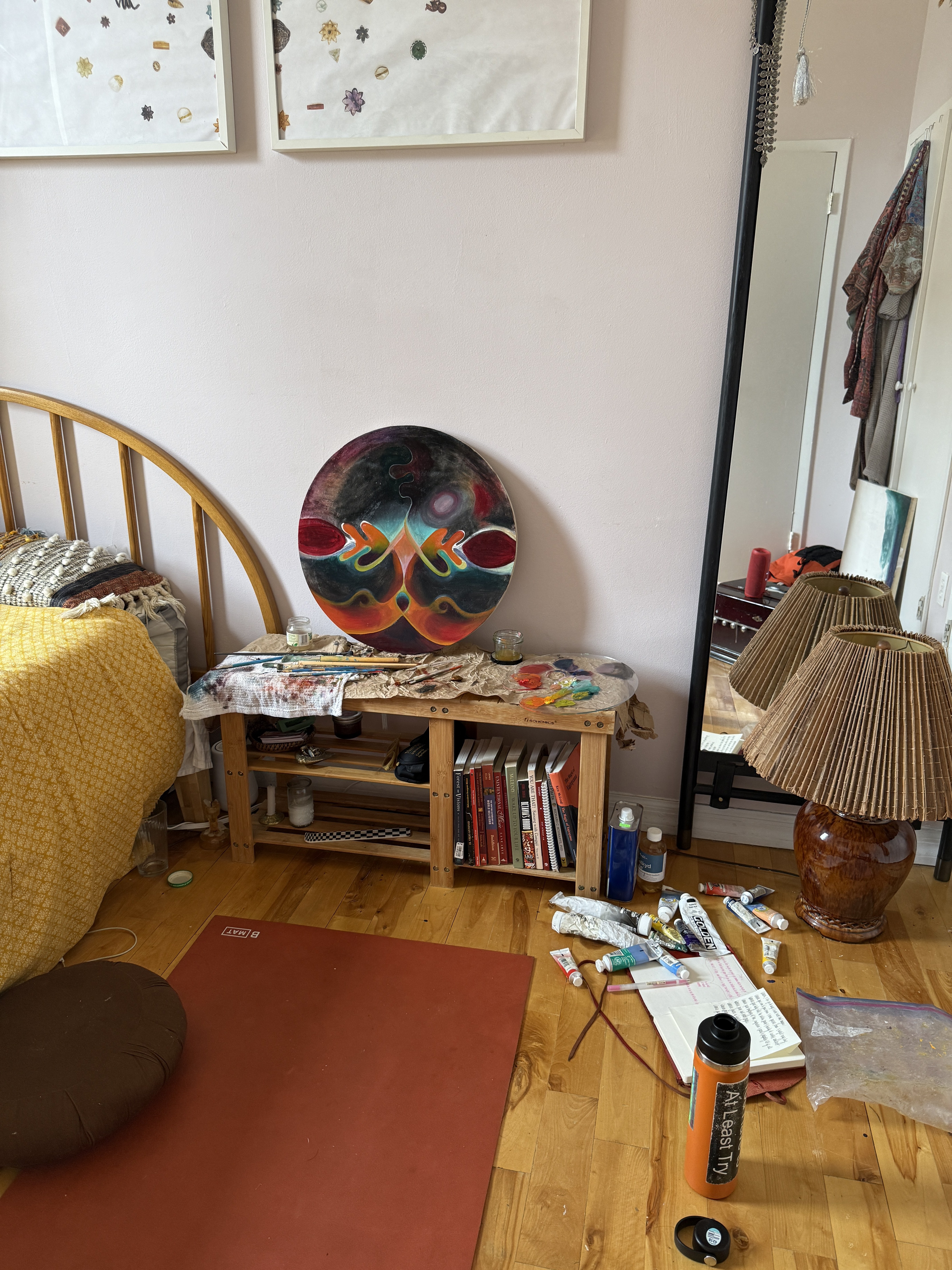 Studio space with circular painting and art supplies